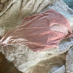 XS/S NWT body suit. Velvet-y texture in light baby link color. One-shoulder.